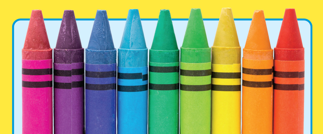 A row of crayons in rainbow colors stand upright side by side